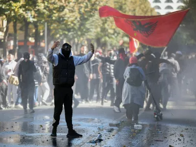 A demonstrator gestures toward police postions near the Ministry of Education during an anti-government protest by students in Tirana, Albania, October 16, 2026. REUTERS/Louisa Gouliamaki