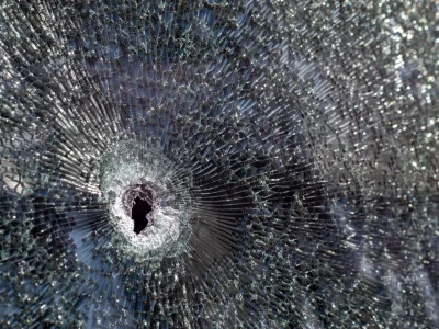 Holes on the windshield of the car, it was shot from a firearm. Bullet holes. Smash car windshield, broken and damaged car. The bullet made a cracked hole in the glass / Foto: Yevhen Roshchyn