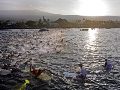 The amateur group of Ironman athletes compete in the morning 2.4-mile swim in Kailua Bay in Kailua-Kona, Hawaii, during the Ironman World Championship Saturday, Oct. 8, 2011. (AP Photo/Chris Stewart)