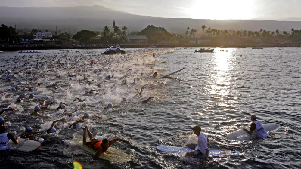 The amateur group of Ironman athletes compete in the morning 2.4-mile swim in Kailua Bay in Kailua-Kona, Hawaii, during the Ironman World Championship Saturday, Oct. 8, 2011. (AP Photo/Chris Stewart)