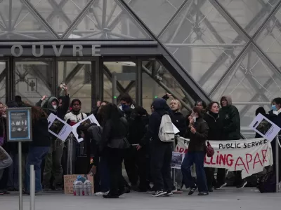 Workers block the entrance of the Louvre museum during a protests against rising living costs, in Paris, Monday, Oct. 19, 2026. (AP Photo/Christophe Ena)