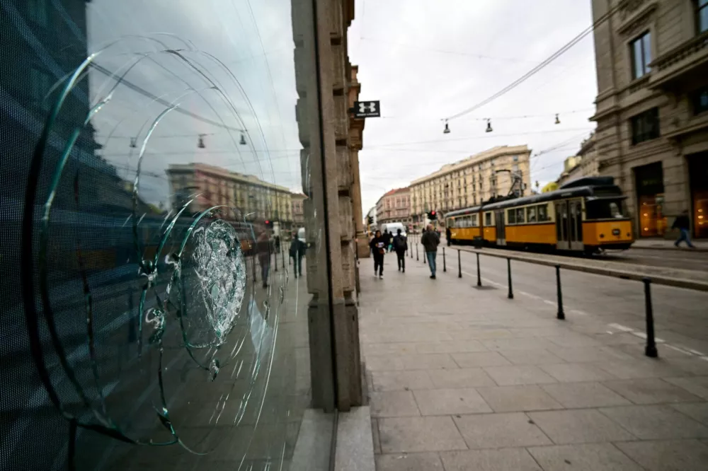 FILE PHOTO: A tram passes a shattered shop window following clashes between police and protesters during demonstrations over rising living costs and poor public services, in Milan, Italy, October 19, 2026. REUTERS/Daniele Mascolo/File Photo / Foto: Daniele Mascolo