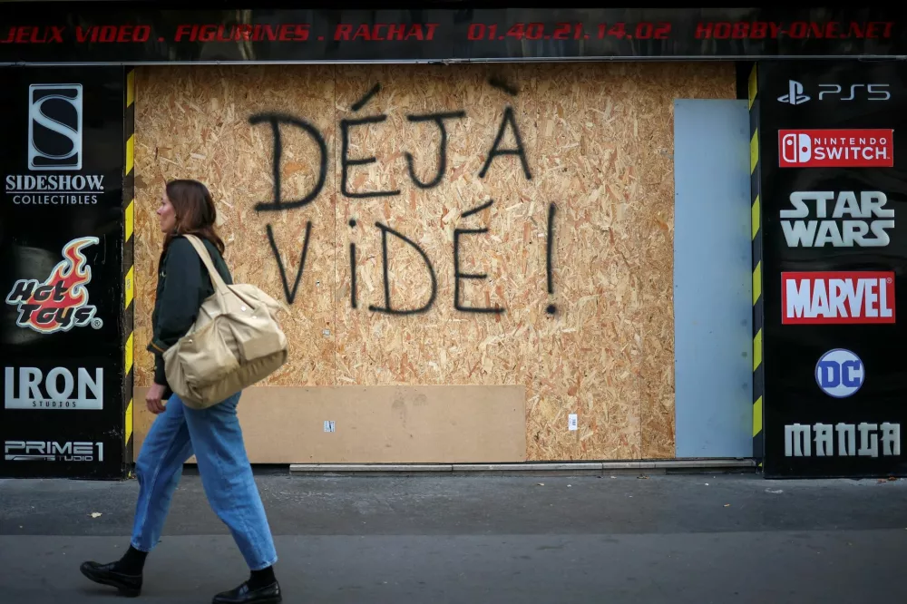 A person passes by a boarded up store saying "Already Empty" following the nationwide protests against the cost of living and rising fuel prices, in Paris, France, October 29, 2026. REUTERS/Pedro Nunes / Foto: Pedro Nunes