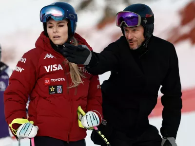 FILE - United States' Lindsey Vonn listens to Aksel Lund Svindal ahead of an alpine ski, women's World Cup downhill in St. Moritz, Switzerland, Friday Dec. 12, 2025. (AP Photo/Gabriele Facciotti, File)