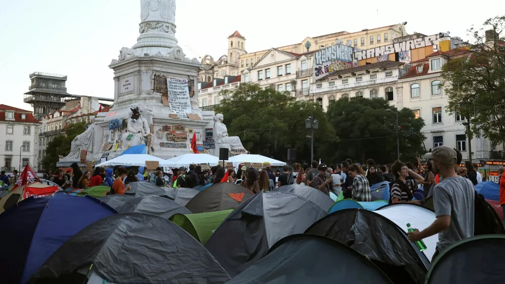 People at a protest camp Rossio square against house crisis and cost of living, in Lisbon, Portugal, October 19, 2026. REUTERS/Pedro Nunes