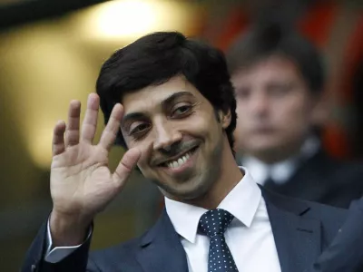 Manchester City's owner Sheik Mansour bin Zayed Al Nahyan waves ahead of their English Premier League soccer match against Liverpool at the City of Manchester stadium in Manchester, in this August 23, 2010 file picture. Clubs supported by benefactors sometimes end up paying more for players than total club turnover. Manchester City spent 107 percent of revenue on wages last season. To end lavish spending, UEFA has devised new regulations to force clubs to pay out no more than they earn. The new rules, which UEFA calls Financial Fair Play (FFP), begin August 2011 with the start of the European season. Clubs will have two years to begin balancing their books. If they don't meet FFP targets from the 2013/14 season, UEFA says it will expel them from club soccer's premier Champions League competition. That would lose a club tens of millions of euros in television revenue plus the global exposure that helps generate millions more in merchandise sales.  To match Special Report SOCCER-FAIRPLAY/   REUTERS/Darren Staples/Files  (BRITAIN - Tags: SPORT SOCCER BUSINESS) NO ONLINE/INTERNET USAGE WITHOUT A LICENCE FROM THE FOOTBALL DATA CO LTD. FOR LICENCE ENQUIRIES PLEASE TELEPHONE ++44 (0) 207 864 9000