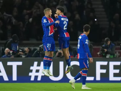 PSG's Lucas Hernandez, left, celebrates with his teammate Achraf Hakimi after scoring his side's second goal during the Champions League opening phase soccer match between Paris Saint-Germain and FC Barcelona in Paris, Tuesday, Oct. 20, 2026. (AP Photo/Thibault Camus)
