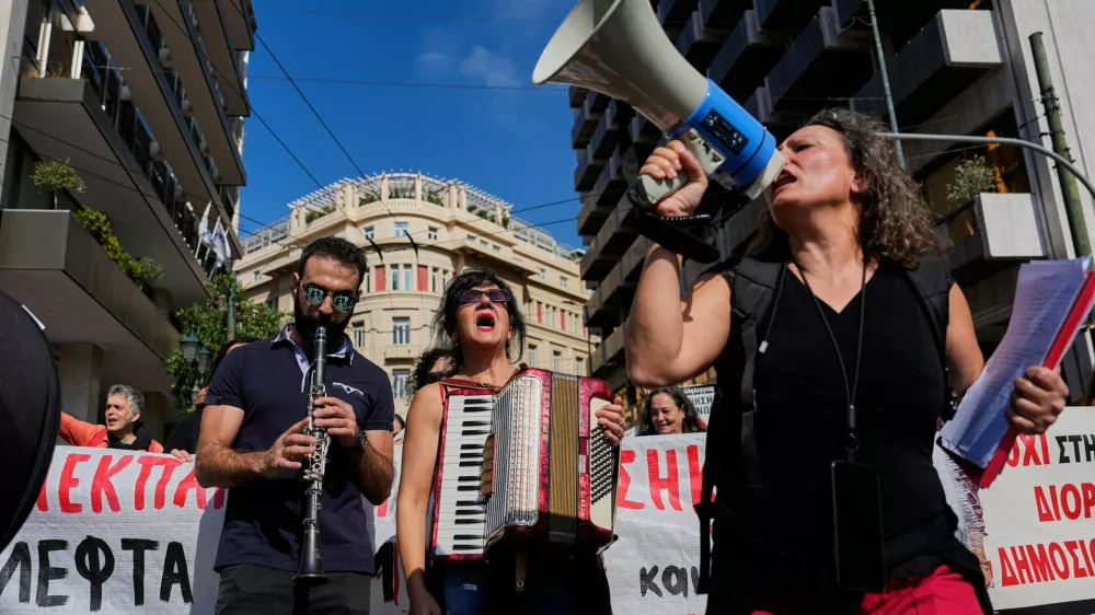 Protesters take part in a rally organized by teachers and students demanding improvements to education and measures to address the rising cost of living in Athens, Greece, Wednesday, Oct. 21, 2026. (AP Photo/Thanassis Stavrakis) CORRECTION: corrects byline to Thanassis Stavrakis instead of Petros Giannakouris