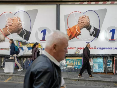 People walk past electoral posters of the Serbian Progressive Party (SNS) in Belgrade, Serbia, October 16, 2026. REUTERS/Djordje Kojadinovic