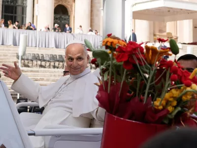 Pope Leo XIV is presented with flowers as he leaves at the end of the general audience in St. Peter's Square at The Vatican, Wednesday, Oct. 21, 2026. (AP Photo/Gregorio Borgia)