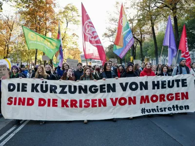 Students hold a banner reading "Today's cuts are tomorrow's crises" as they participate in a protest against the government's cost-cutting for universities, in Vienna, Austria, October 22, 2026. REUTERS/Lisa Leutner