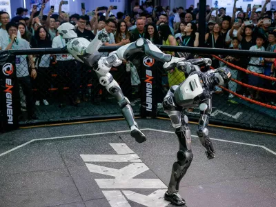 Robots fight during an MMA-style performance at Engine AI booth at the 2026 World Robot Conference, in Beijing, China, August 19, 2026. REUTERS/Maxim Shemetov Purchase Licensing Rights