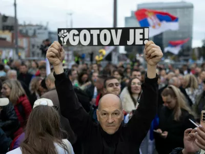 A supporter of the electoral list "Student List - Students Win" holds a sign reading "He is Finished!" referring to former Serbia's President Aleksandar Vucic during a final campaign rally at Slavija Square in Belgrade, Serbia, October 22, 2026. REUTERS/Uros Arsic