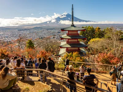 Arakura, Japan - 17 November 2024: People at Chureito Pagoda in autumn with Mount Fuji at background
