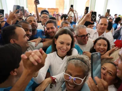 In this photo released by Vente Venezuela Press Office, Venezuelan opposition leader Maria Corina Machado greets supporters at a church in Barquisimeto, Venezuela, Sunday, Oct. 25, 2026. (Vente Venezuela Press Office via AP)