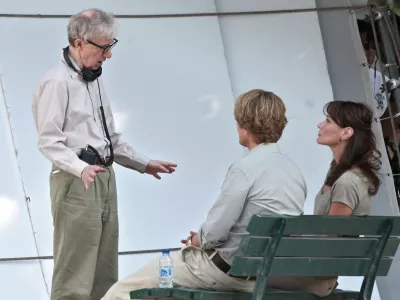 French President Nicolas Sarkozy's wife Carla Bruni Sarkozy, right, is pictured with U.S director Woody Allen, left, and U.S actor Owen Wilson, center, during the filming of "Midnight in Paris", directed by Woody Allen, in Paris, Wednesday, July 28, 2010. (AP Photo/Thibault Camus)