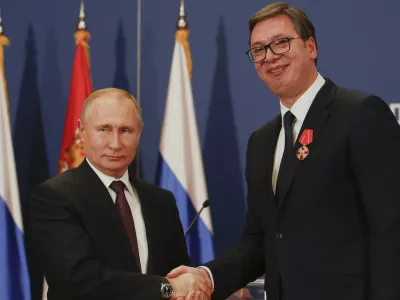 FILE - Russian President Vladimir Putin, left, shakes hands with Serbian President Aleksandar Vucic after being awarded the Order of Alexander Nevsky in Belgrade, Serbia, Thursday, Jan. 17, 2019. (AP Photo/Darko Vojinovic, File)