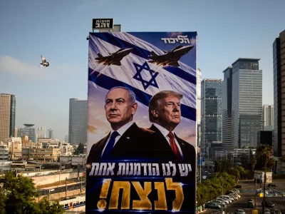 A pigeon flies past a Likud Party campaign billboard featuring U.S. President Donald Trump and Israeli Prime Minister Benjamin Netanyahu, with a Hebrew message reading, "We have one opportunity to win," in Tel Aviv, Israel, Monday, Oct. 26, 2026. (AP Photo/Oded Balilty)