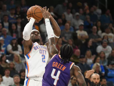 Oklahoma City Thunder guard Shai Gilgeous-Alexander (2) looks to shoot over Phoenix Suns guard Jalen Green (4) during the second half of an NBA basketball game, Monday, Oct. 26, 2026, in Oklahoma City. (AP Photo/Kyle Phillips)
