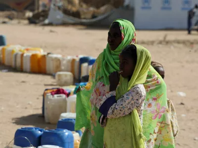 Sudanese refugee women react next to a line of empty jugs as families wait to collect water inside the Iridimi refugee camp, northwest of Iriba in Wadi Fira province, eastern Chad, November 27, 2025. REUTERS/Amr Abdallah Dalsh