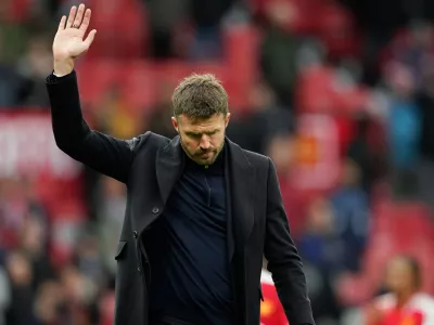 Manchester United's head coach Michael Carrick waves to supporters after his team lost the English Premier League soccer match between Manchester United and Bournemouth in Manchester, England, Sunday, Oct. 25, 2026. (AP Photo/Dave Thompson)