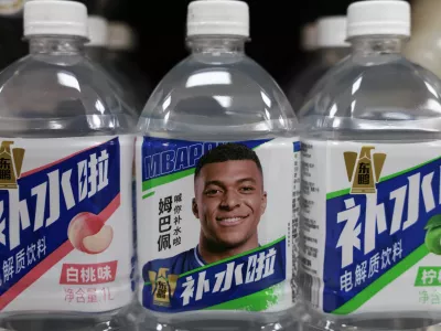 Bottled drinks by Eastroc Beverage with images of French soccer player Kylian Mbappe are displayed on a shelf at a store, in Beijing, China October 27, 2026. REUTERS/Tingshu Wang