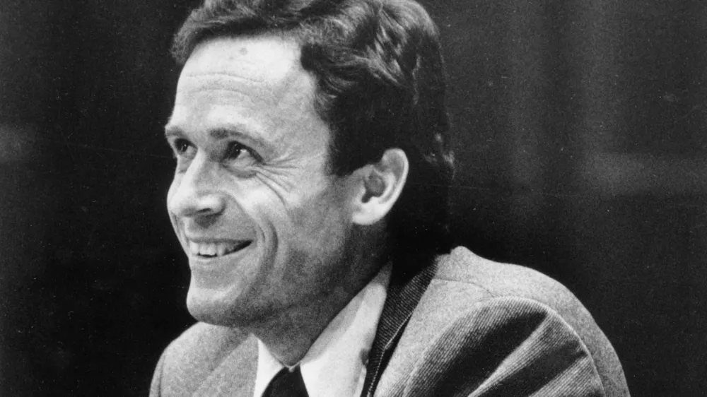 FILE - Ted Bundy smiles during the second day of jury selection for his murder trial in a Dade County courtroom in Miami, June 27, 1979. (AP Photo, Pool, File)