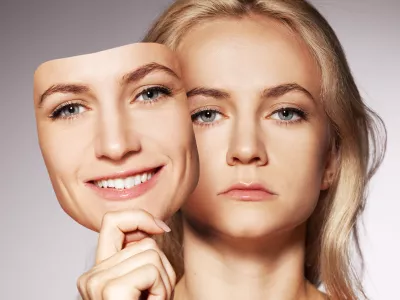 Woman hiding under the happy mask. Hypocritical, insincere, two-faced female