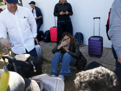 A survivor reacts while waiting to board a bus outside the municipal center where they have been taken, following the collision of two high-speed trains between the towns of Mora and Orgaz, in Urda, Spain, October 28, 2026. REUTERS/Susana Vera