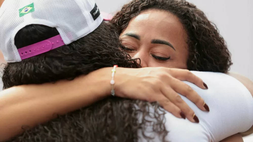People embrace on the day of a protest to mark the one-year anniversary of a police operation that resulted in 122 deaths, in Rio de Janeiro, Brazil, October 28, 2026. REUTERS/Tita Barros