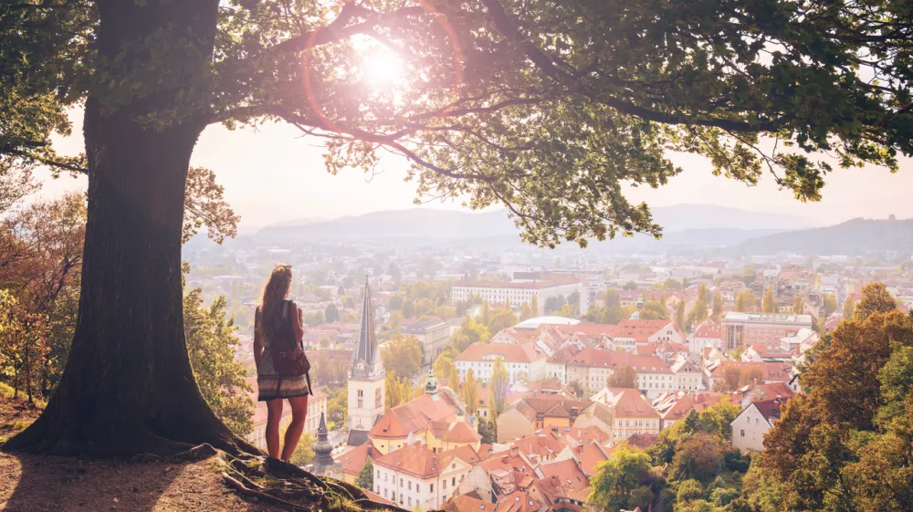 Female tourist enjoying sunset above city of ljubljana panoramic view- Slovenia