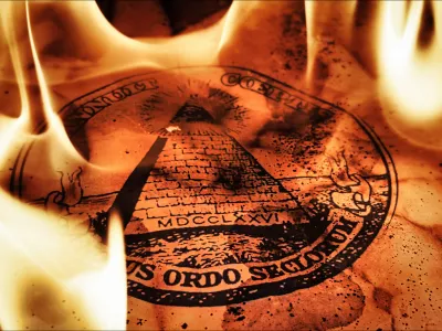 An ancient burnt parchment paper featuring the printed Masonic All Seeing Eye pyramid symbol, dramatically engulfed and illuminated by real blazing fire flames creating a mysterious, occult atmosphere for secret society concepts.