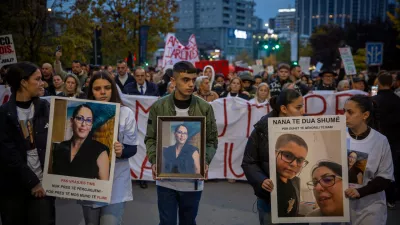 Family members of Arlinda Zekaj hold her picture during a protest in Pristina, Kosovo, as thousands gather to condemn the killing of the Kosovo-American woman, whose death sparked public outrage and renewed calls for accountability over violence against women, on Wednesday, Oct. 28, 2026. (AP Photo/Visar Kryeziu)