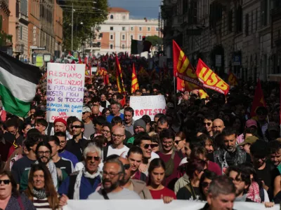 Workers, students and activists demonstrate during a nationwide general strike called by grassroots unions to protest rising living costs, low wages and military spending, Friday, Oct. 30, 2026, in Rome. (AP Photo/Alessandra Tarantino)