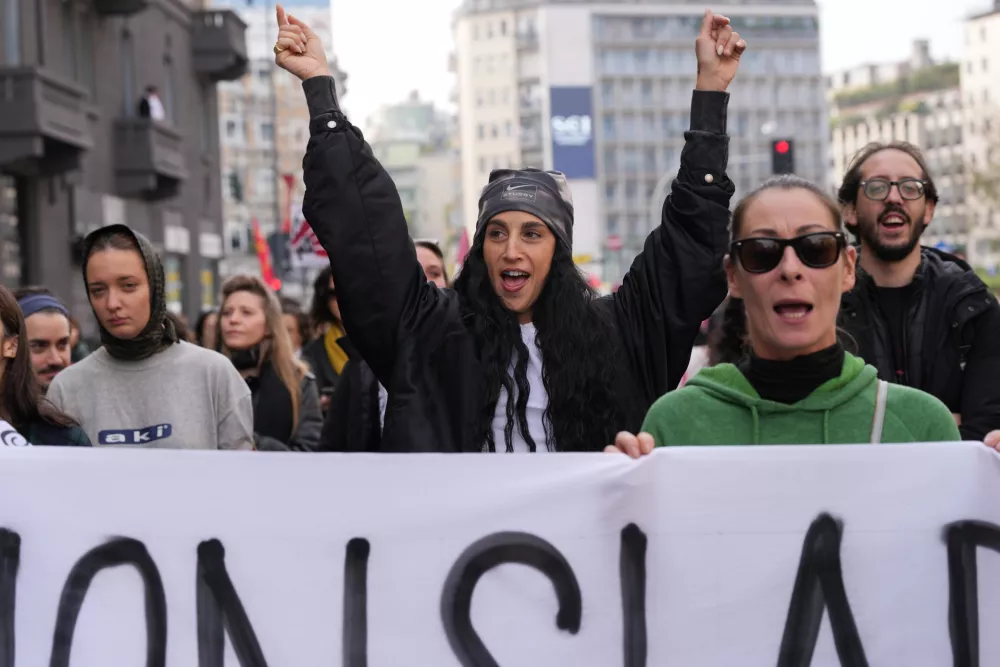Workers, students and activists demonstrate during a nationwide general strike called by grassroots unions to protest rising living costs, low wages and military spending, Friday, Oct. 30, 2026, in Milan. (AP Photo/Antonio Calanni)