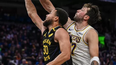 Los Angeles Lakers guard Luka Doncic (77) blocks Golden State Warriors guard Stephen Curry (30) during the second half of an NBA Cup basketball game, Saturday, Oct. 30, 2026, in San Francisco. (AP Photo/Justine Willard)