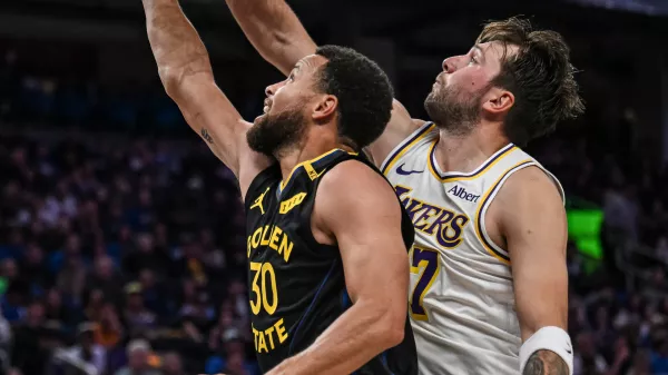 Los Angeles Lakers guard Luka Doncic (77) blocks Golden State Warriors guard Stephen Curry (30) during the second half of an NBA Cup basketball game, Saturday, Oct. 30, 2026, in San Francisco. (AP Photo/Justine Willard)