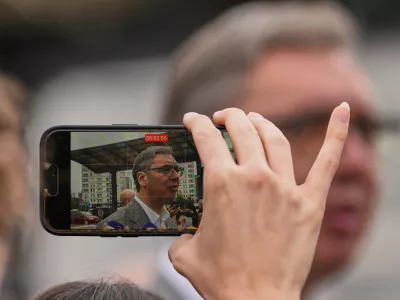 A person records video of Aleksandar Vucic, leader of the right-wing Serbian Progressive Party (SNS), speaking to media after voting in a parliamentary election in Belgrade, Serbia, Sunday, Oct. 25, 2026. (AP Photo/Darko Vojinovic)