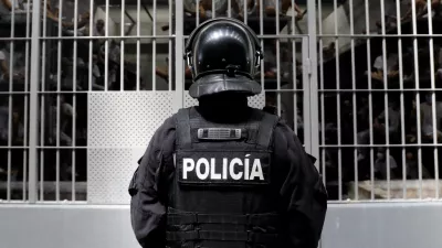 A police officer stands as prisoners look on from a cell during a tour of El Salvador's Minister of Justice and Public Security Gustavo Villatoro and Peru's President Keiko Fujimori (not pictured) to the Terrorism Confinement Center (CECOT) in Tecoluca, El Salvador, October 29, 2026. REUTERS/Jose Cabezas REFILE - CORRECTING "TERRORIST CONFINEMENT CENTER" TO "TERRORISM CONFINEMENT CENTER".