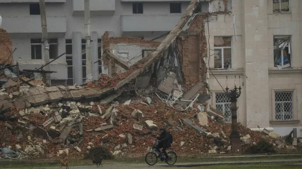 A resident rides a bicycle past a damaged building, amid Russia's attack on Ukraine, in the frontline city of Kherson, Ukraine, October 30, 2026. REUTERS/Nina Liashonok