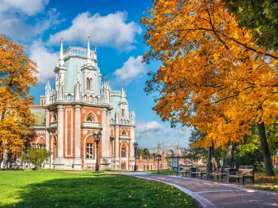 Part of the palace in Tsaritsyno in Moscow on a bright sunny autumn day and a great golden tree