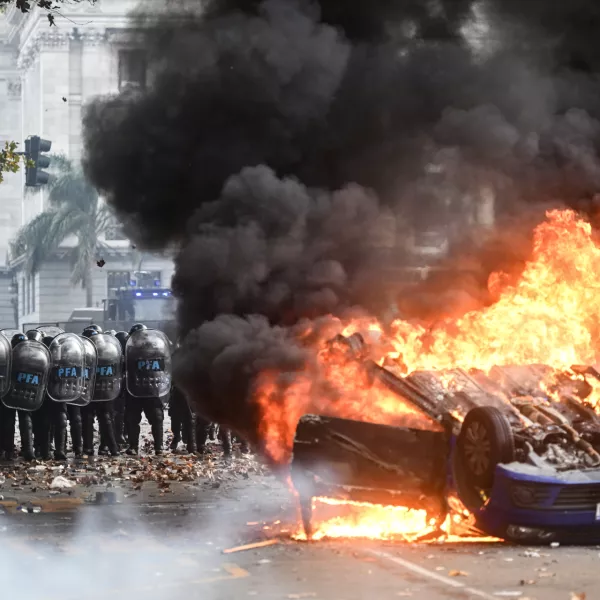 12 June 2024, Argentina, Buenos Aires: A Volkswagen car burns in front of Congress during a protest against the reform plan of President Milei's ultra-liberal government, which is being debated in Congress. Among other things, the plan provides for new regulations for high investments and a more flexible labour market. Photo: Fernando Gens/dpa