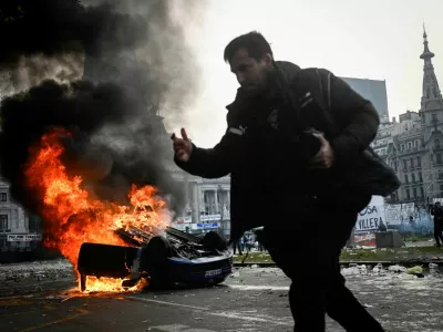 A car burns during a protest near the National Congress, on the day Senators debate Argentina's President Javier Milei's economic reform bill, known as the "omnibus bill", in Buenos Aires, Argentina, June 12, 2024. REUTERS/Mariana Nedelcu