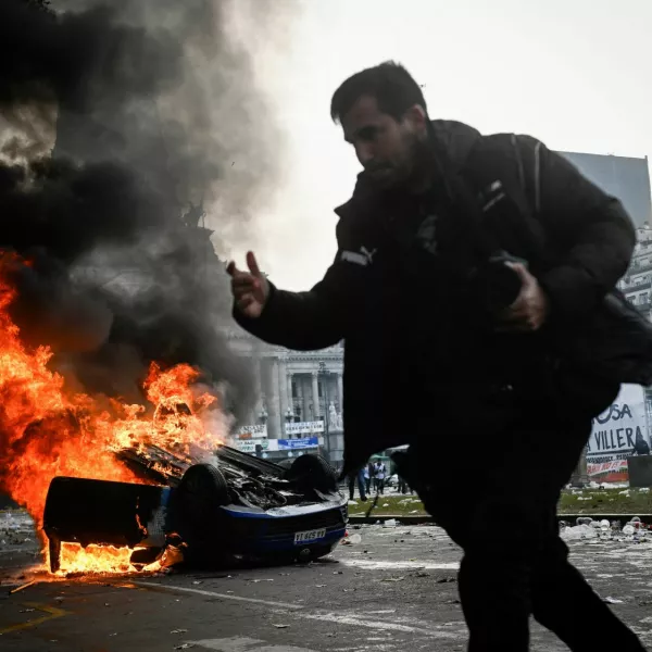 A car burns during a protest near the National Congress, on the day Senators debate Argentina's President Javier Milei's economic reform bill, known as the "omnibus bill", in Buenos Aires, Argentina, June 12, 2024. REUTERS/Mariana Nedelcu