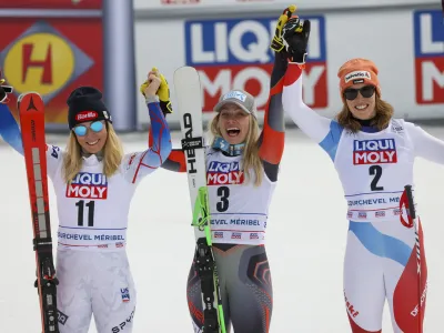 From left, second placed United States' Mikaela Shiffrin, winner Norway's Ragnhild Mowinckel and third placed Switzerland's Michelle Gisin celebrate in the finish line of an alpine ski, women's World Cup Finals super-G, in Courchevel, France, Thursday, March 17, 2022. (AP Photo/Alessandro Trovati)