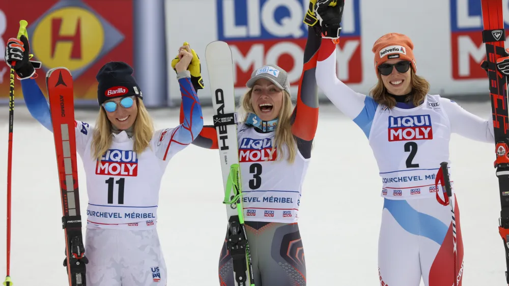 From left, second placed United States' Mikaela Shiffrin, winner Norway's Ragnhild Mowinckel and third placed Switzerland's Michelle Gisin celebrate in the finish line of an alpine ski, women's World Cup Finals super-G, in Courchevel, France, Thursday, March 17, 2022. (AP Photo/Alessandro Trovati)