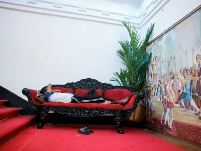 A man sleeps on a couch inside the President's house on the following day after demonstrators entered the building, after President Gotabaya Rajapaksa fled, amid the country's economic crisis, in Colombo, Sri Lanka July 10, 2022. REUTERS/Dinuka Liyanawatte