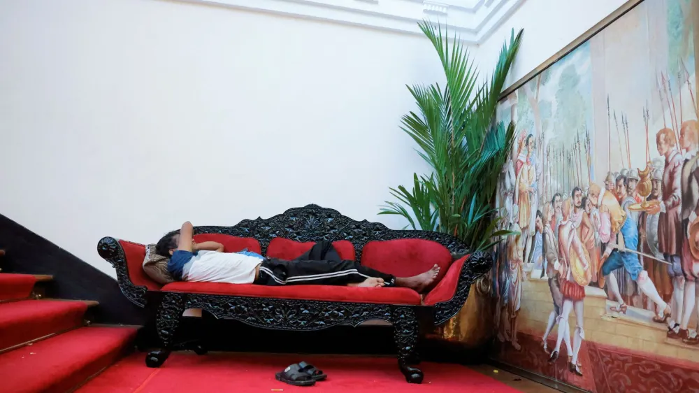 A man sleeps on a couch inside the President's house on the following day after demonstrators entered the building, after President Gotabaya Rajapaksa fled, amid the country's economic crisis, in Colombo, Sri Lanka July 10, 2022. REUTERS/Dinuka Liyanawatte