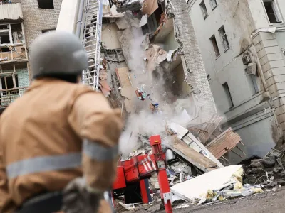 Firefighters remove debris after a military strike hit a building, as Russia's invasion of Ukraine continues, in Kharkiv, Ukraine July 11, 2022. REUTERS/Nacho Doce