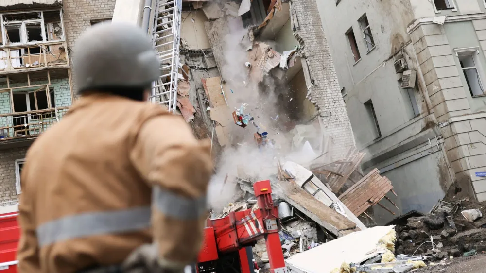 Firefighters remove debris after a military strike hit a building, as Russia's invasion of Ukraine continues, in Kharkiv, Ukraine July 11, 2022. REUTERS/Nacho Doce